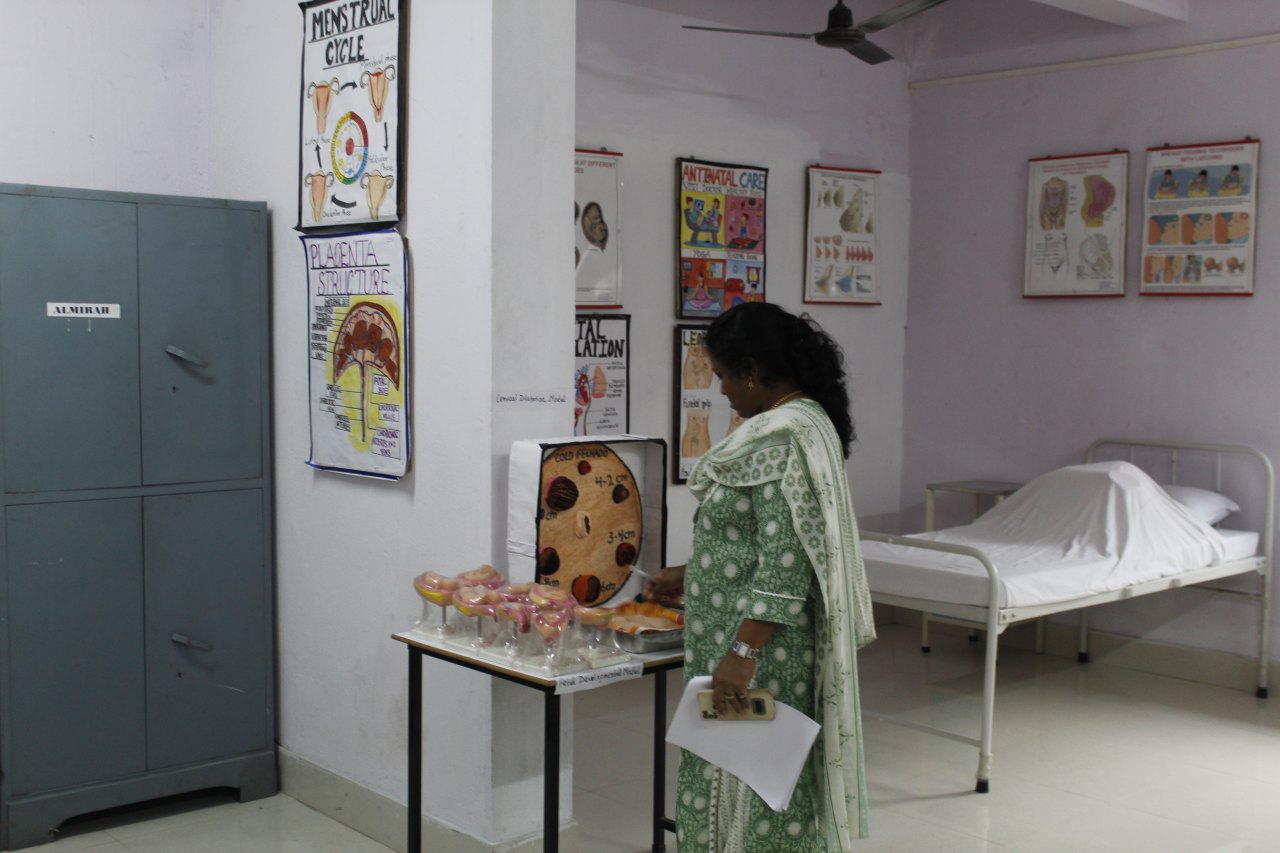 Nursing foundation lab with demonstration bed and teaching charts
