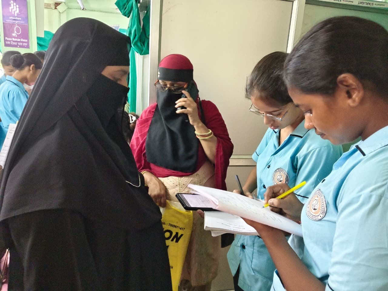 Recording case histories at a community health camp